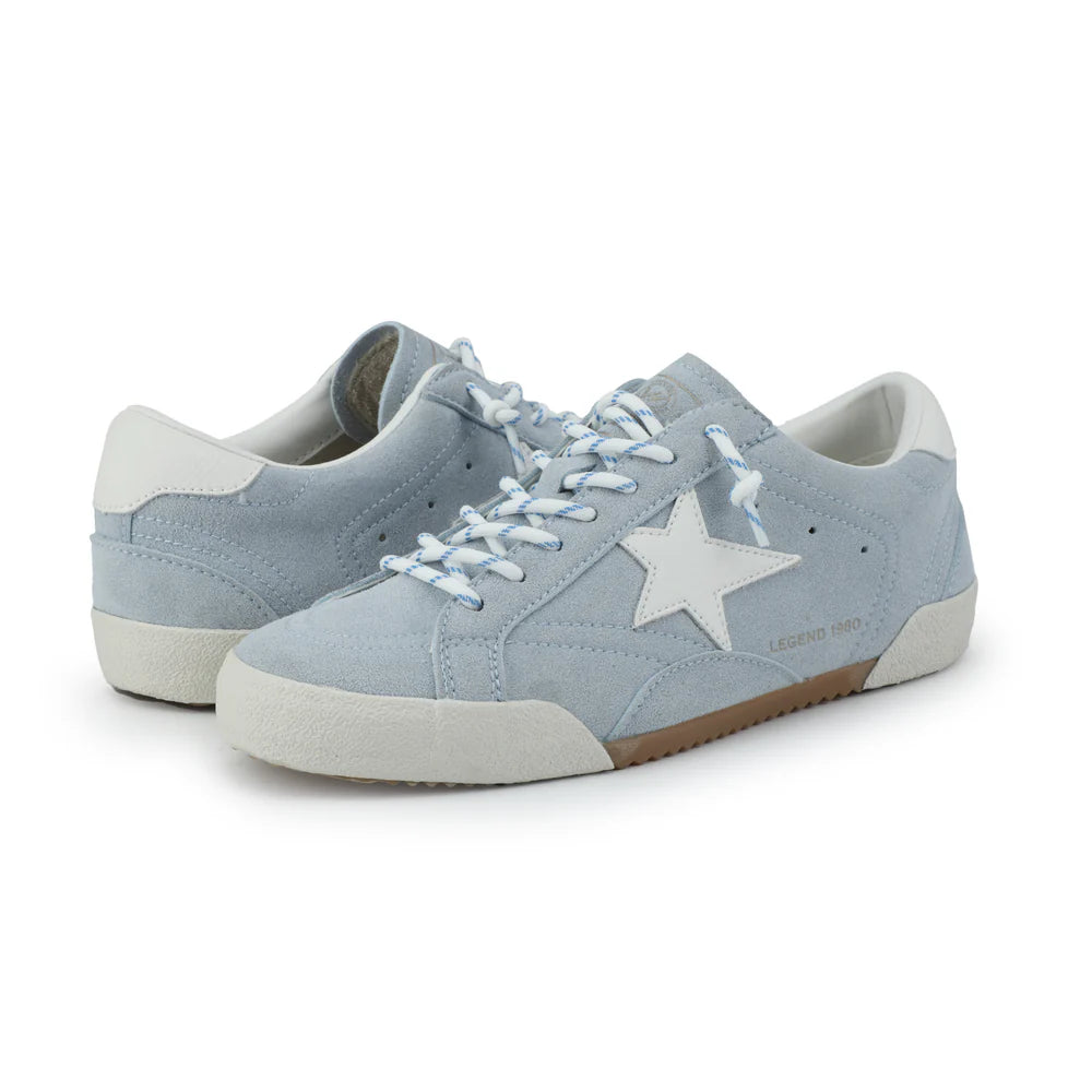 Light blue sneakers with a star design on a white background