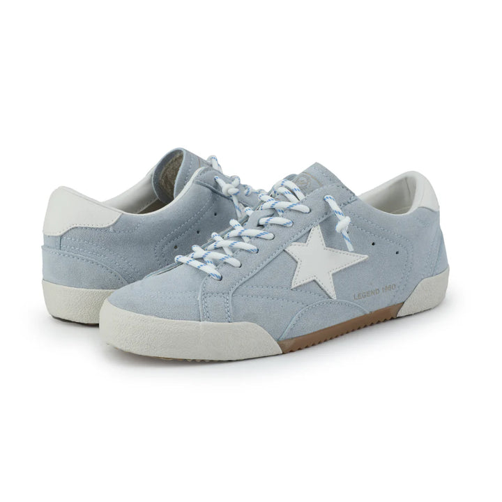 Light blue sneakers with a star design on a white background