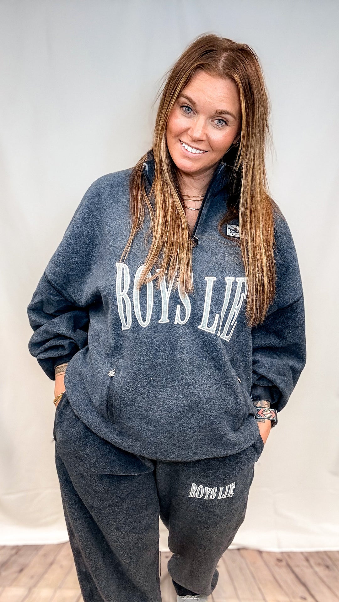 Woman wearing navy blue top with &