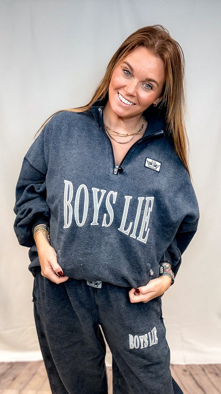 Woman wearing navy crewneck sweatshirt with &
