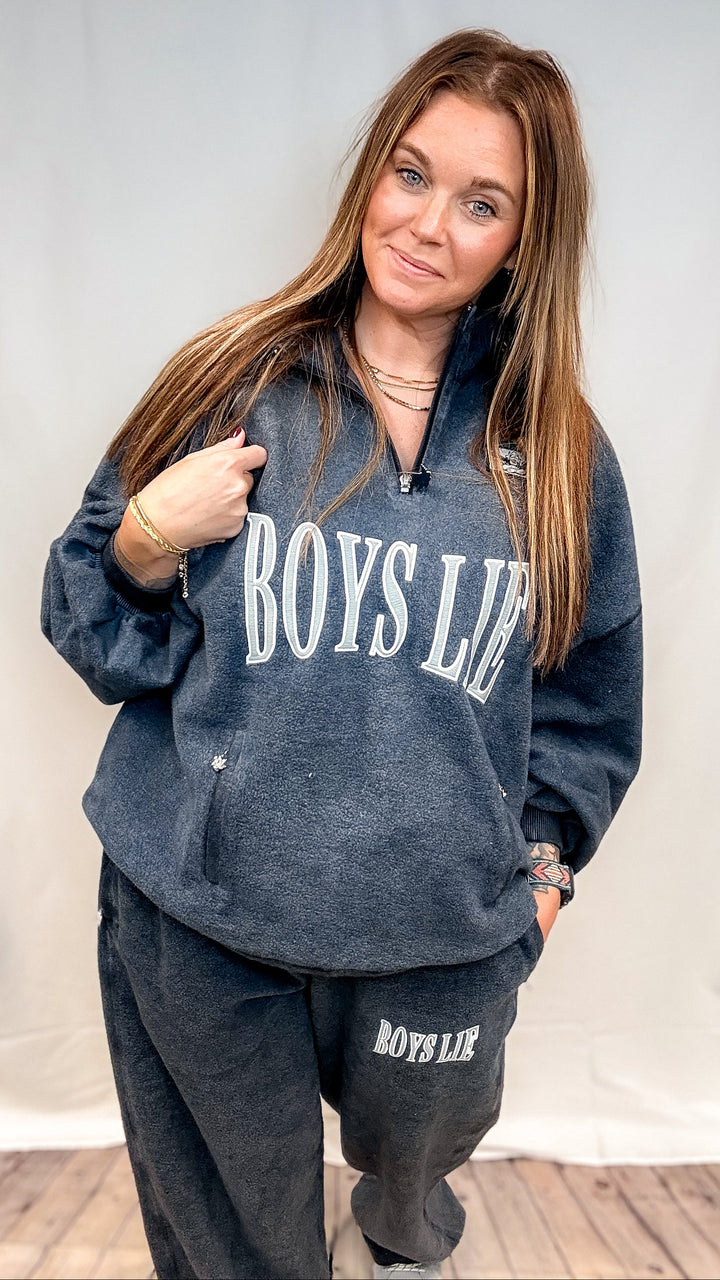 Woman wearing navy crewneck sweatshirt with &