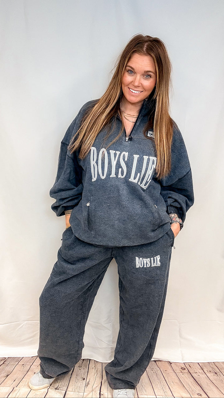 Woman wearing matching navy sweatsuit with &