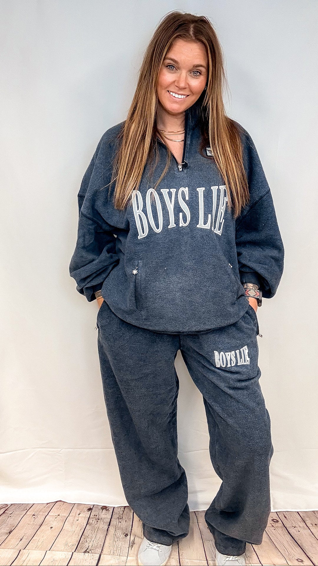 Woman wearing matching navy sweatsuit with &