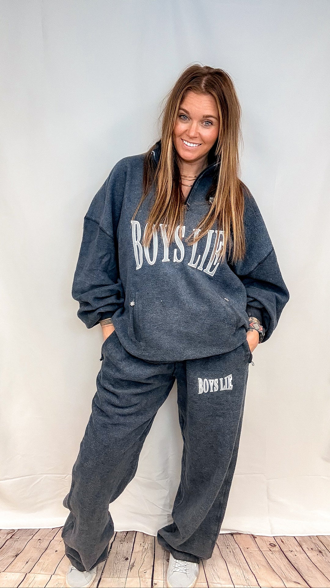 Woman wearing matching navy sweatsuit with &