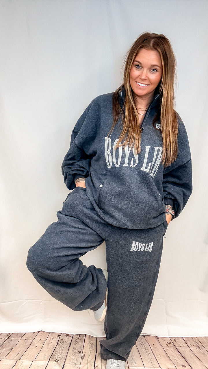 Woman wearing matching navy sweatsuit with &