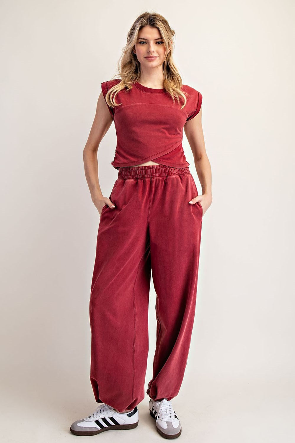 Woman wearing a red outfit with a plain background