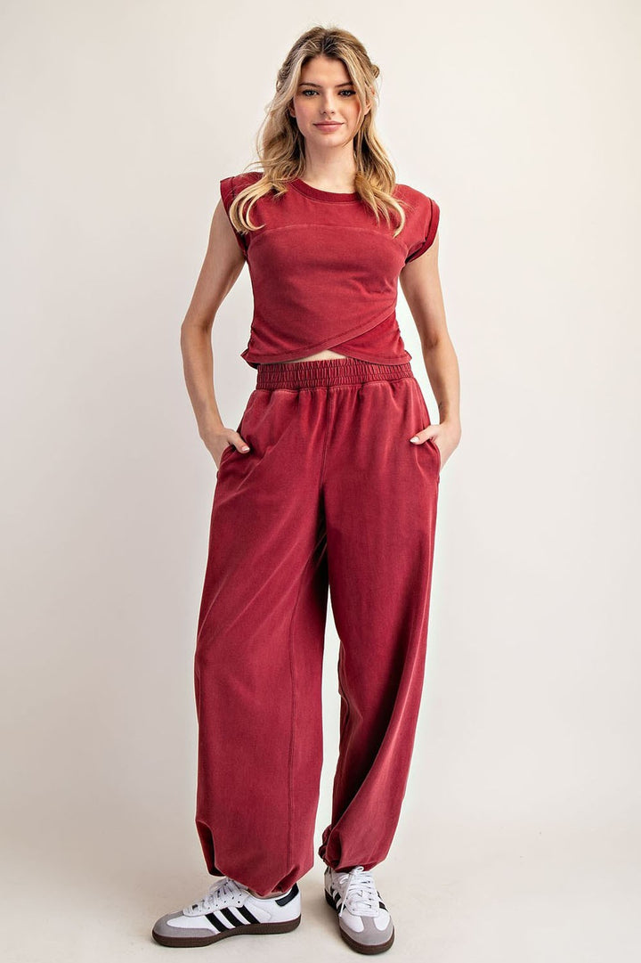 Woman wearing a red outfit with a plain background