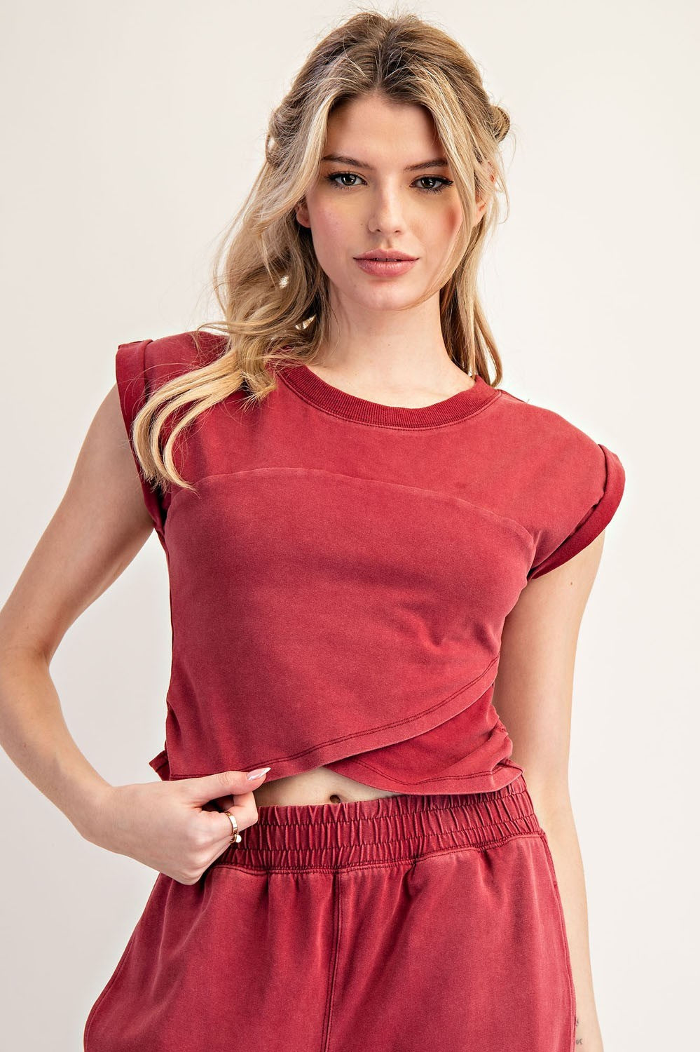Woman wearing a red outfit against a plain background