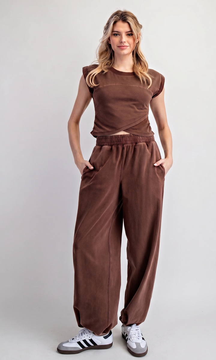 Woman wearing a brown outfit with a plain background