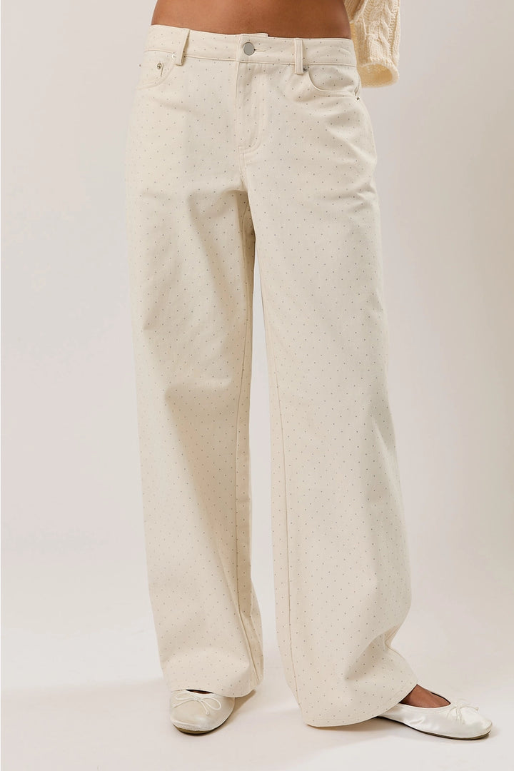 White wide-leg jeans worn by a person on a plain background