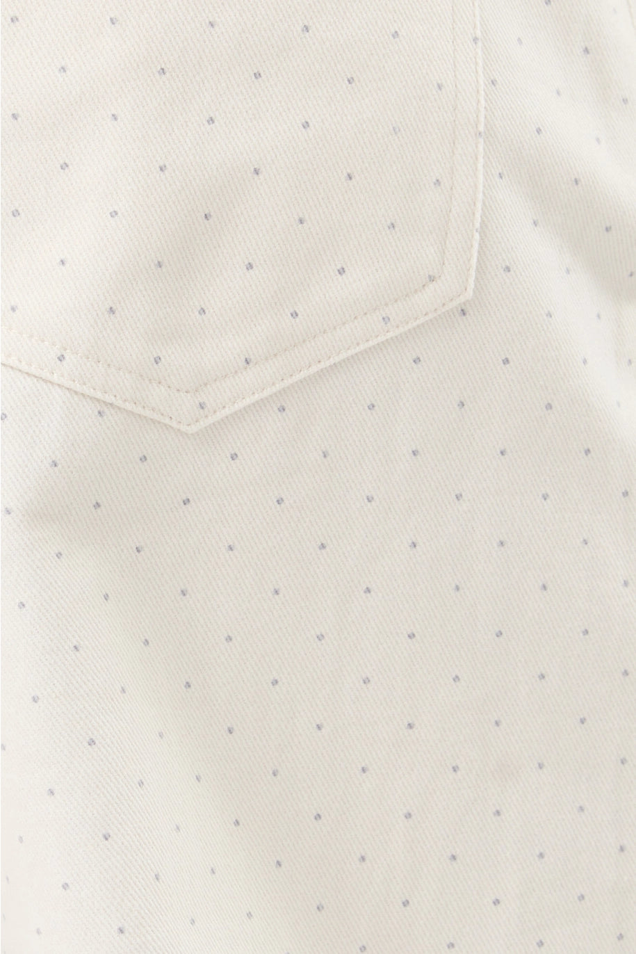Close-up of  white pants with small gray dots and a pocket.