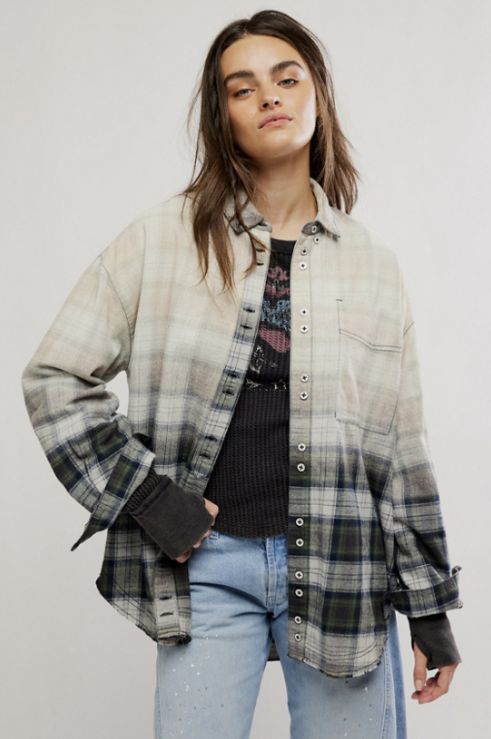 Woman wearing ombre flannel shirt and jeans on plain background