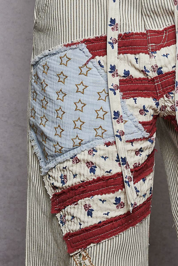 Close-up of a patchwork quilt with star patterns on a textured surface
