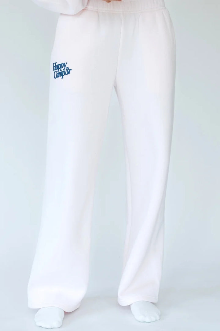 Person wearing light pink sweatpants with &