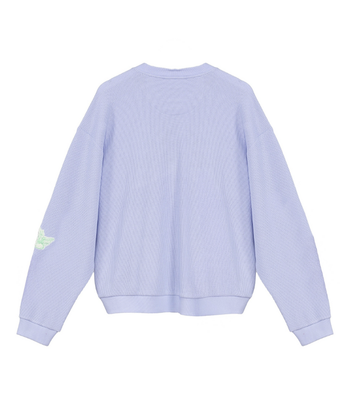 A light lavender ribbed knit crewneck sweatshirt shown from the back, featuring a small light green wing graphic on the left sleeve, set against a plain white background.