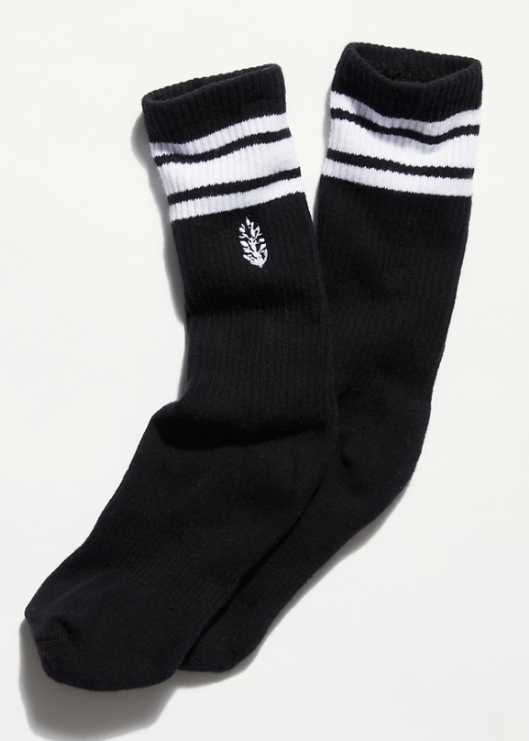Pair of black and white stripe logo tube socks on plain background
