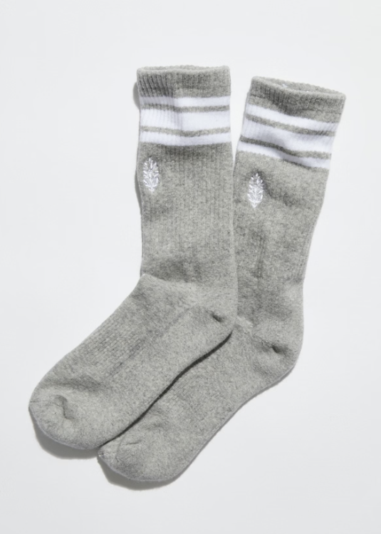 Pair of grey stripe tube socks with FP Movement logo on front on plain background