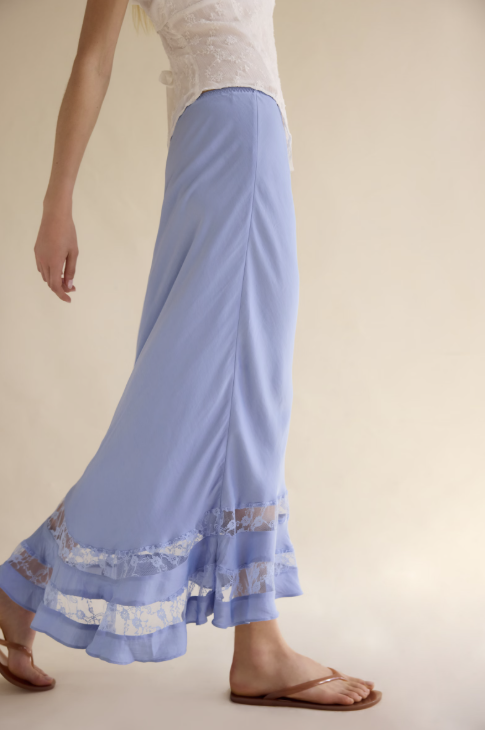 Light blue skirt with lace trim worn by a person on a plain background