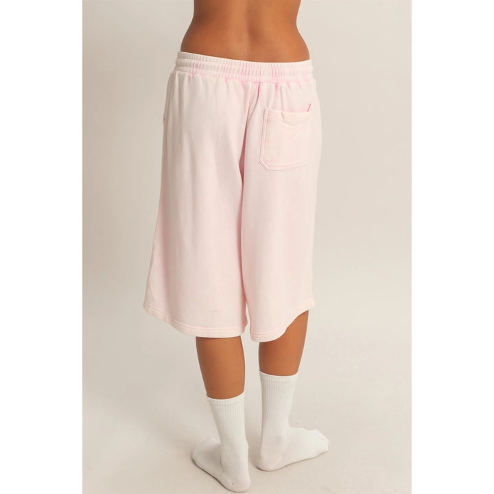 Light pink shorts worn by a person on a plain background