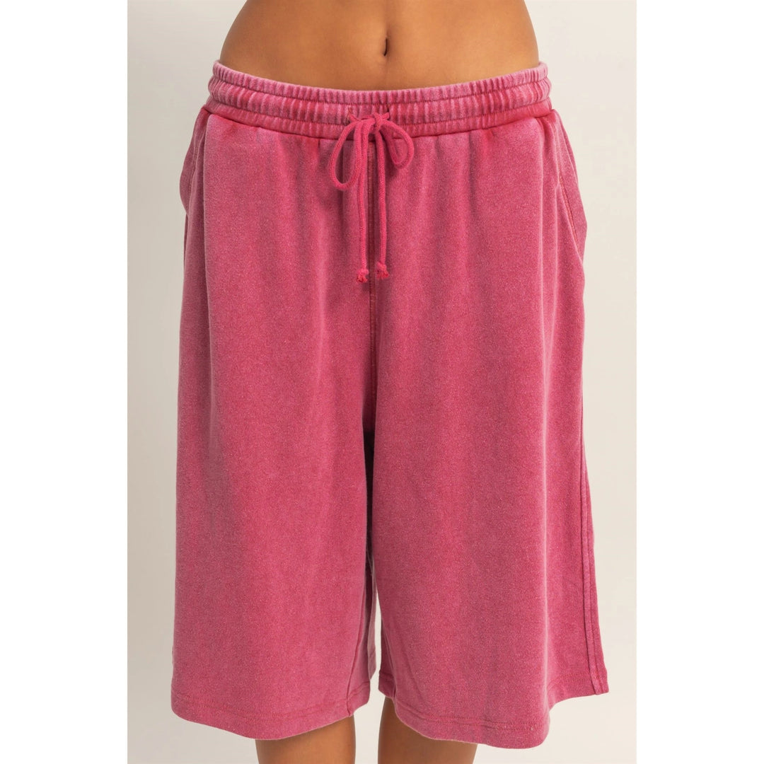Pink shorts with a drawstring on a beige background