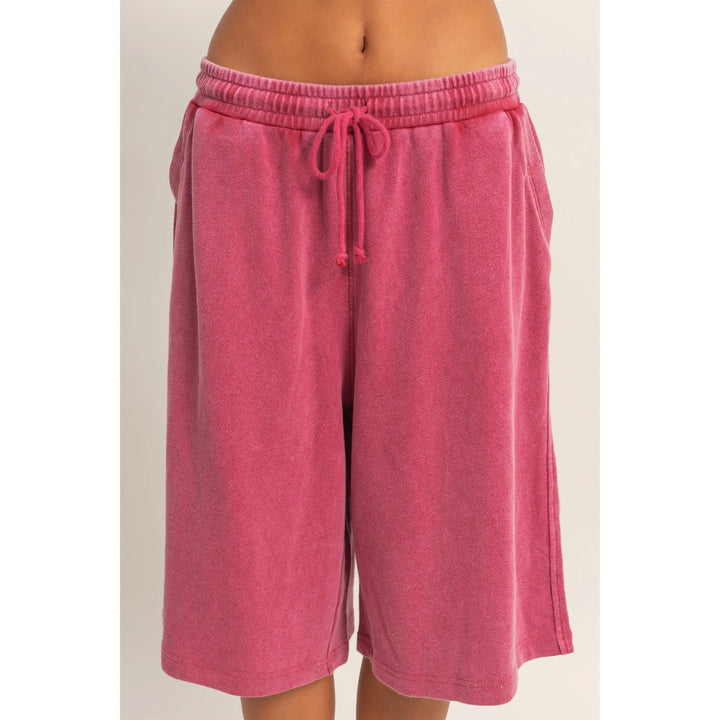 Pink shorts with a drawstring on a beige background