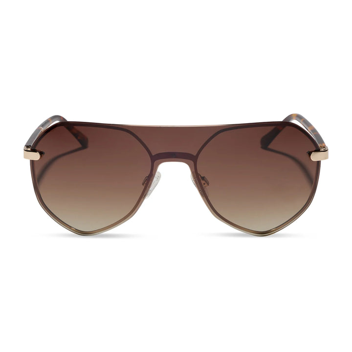 A pair of oversized shield-style sunglasses with gradient brown lenses and gold metal frames, shown against a plain white background.