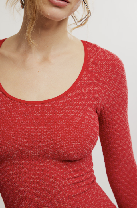 Close up of woman wearing long sleeve red textured top