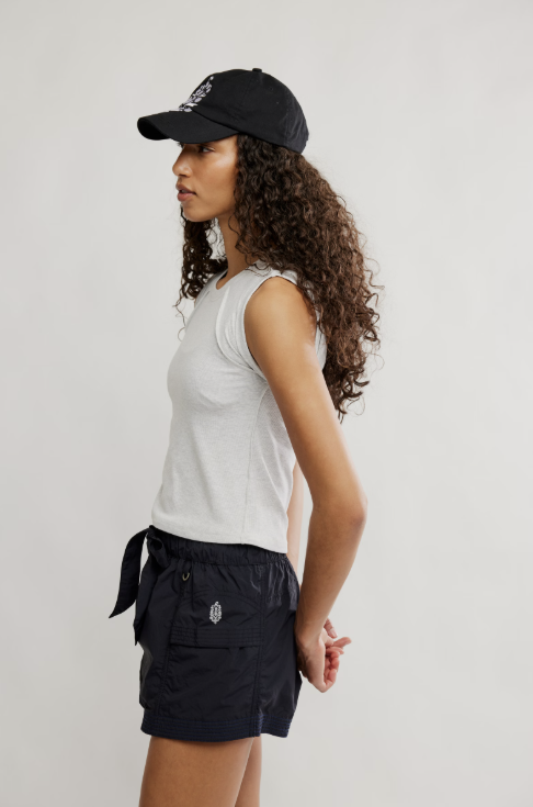 Woman wearing grey tee and black skirt on white background