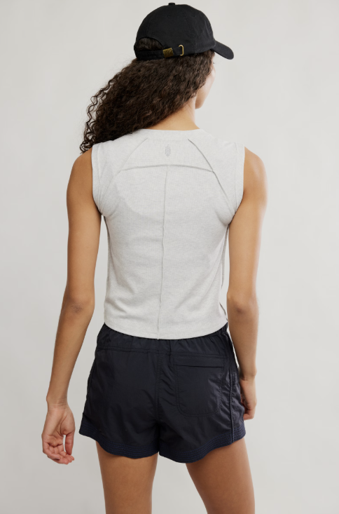 Woman wearing grey tee and black skirt on white background