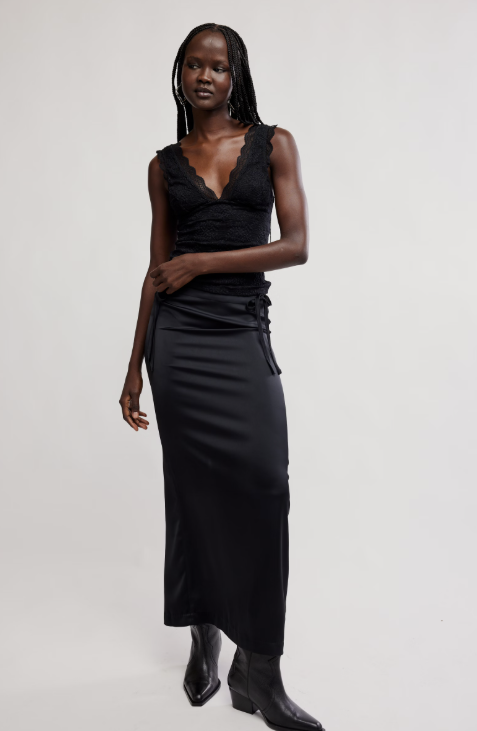 Woman wearing a black dress with a plain background