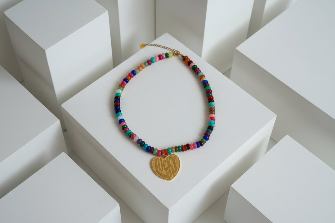 Multicolor necklace with gold heart pendant that says Lucky