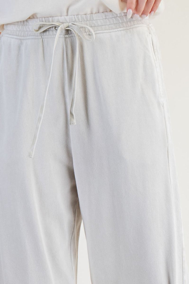 White pants with a drawstring waist on a white background