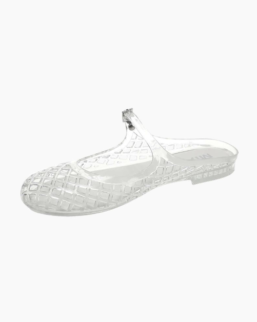 A single clear jelly T-strap flat shoe with a textured grid pattern, shown from a side profile on a light gray background.