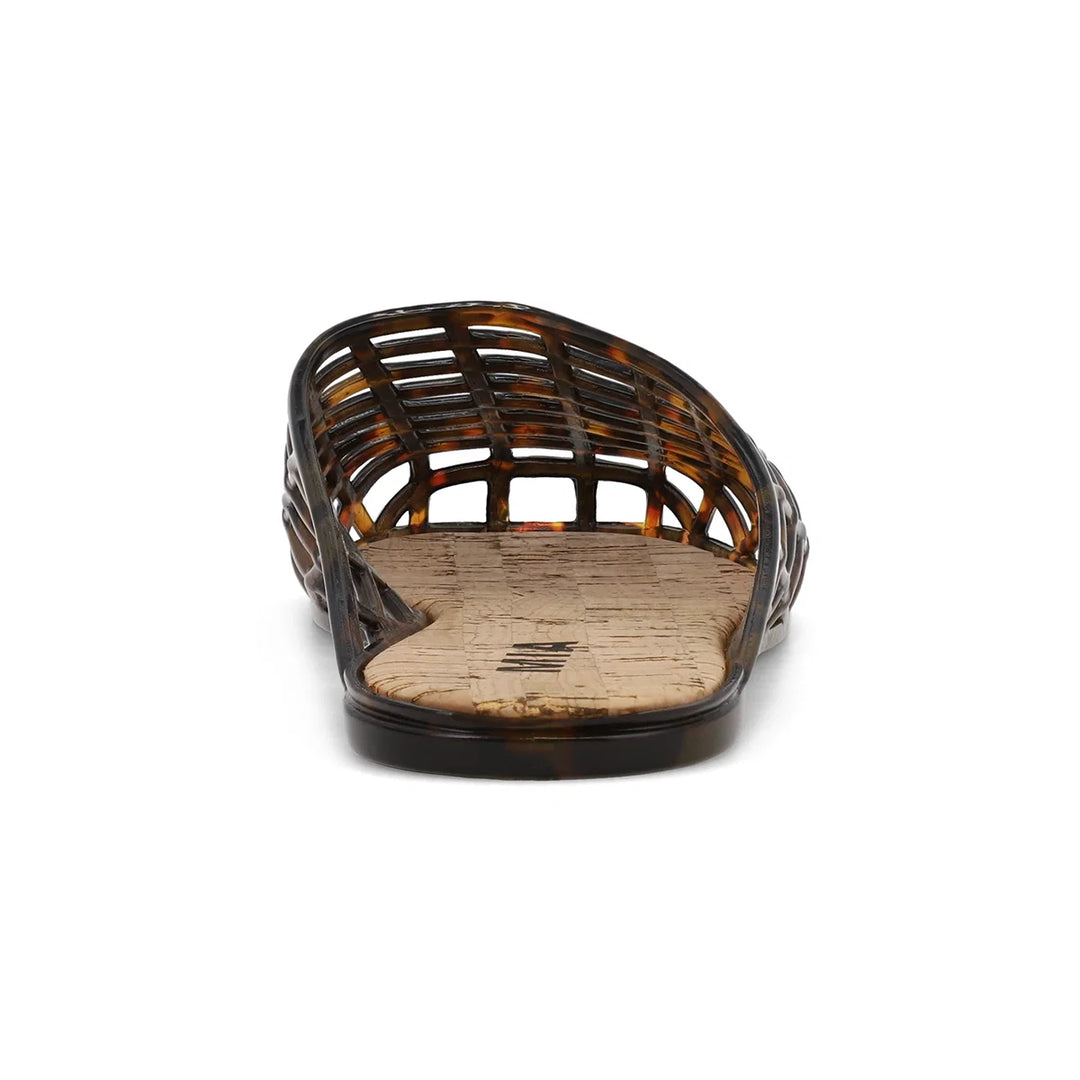 Tortoise jelly shoe with cork footbed on white background