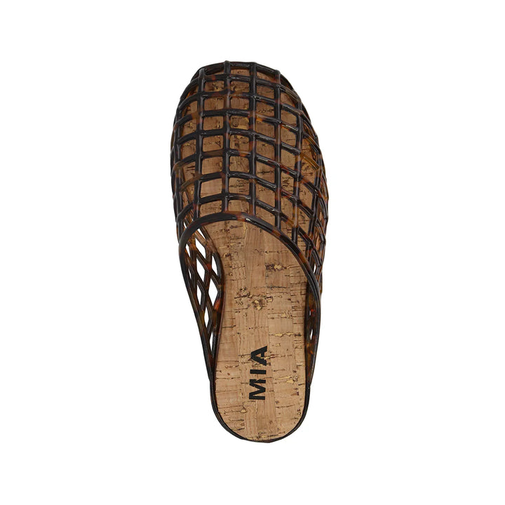 Tortoise jelly shoe with cork footbed on white background