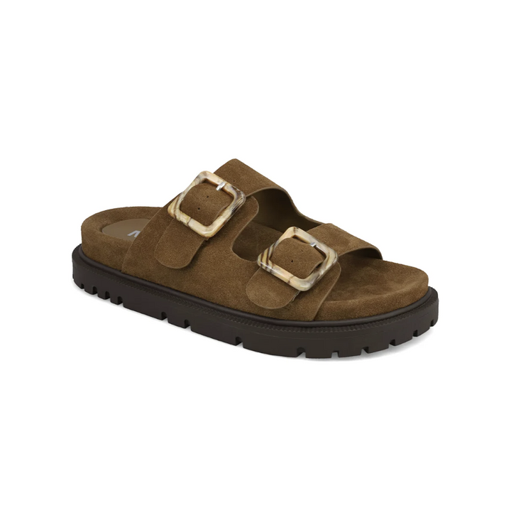 A single brown double-strap slide sandal with textured suede-like uppers, large square buckles, and a thick black lug sole, shown on a plain white background.