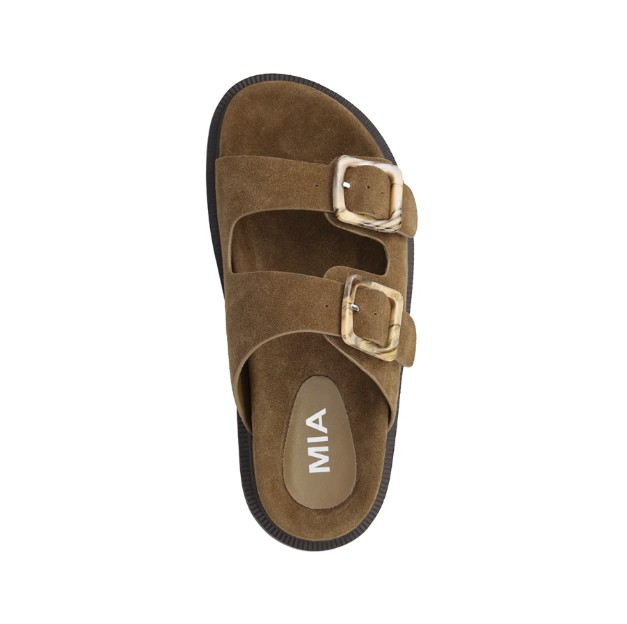 A single brown suede double-strap sandal with gold-tone buckles and a black sole, shown from a top-down view on a white background. The insole features the brand name &