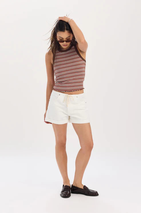 Woman wearing a striped tank top and white shorts on a white background
