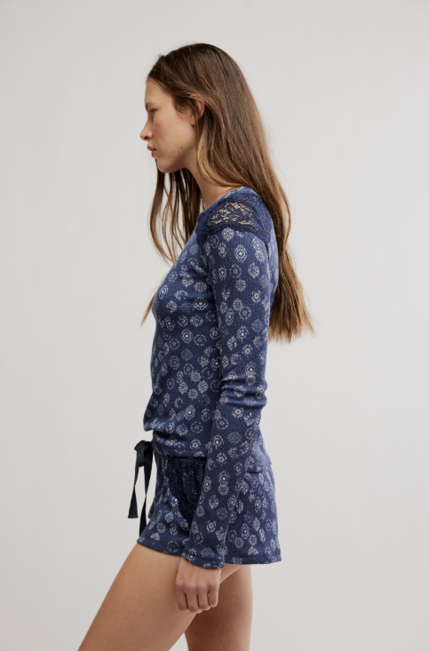 Woman wearing blue patterned top on white background