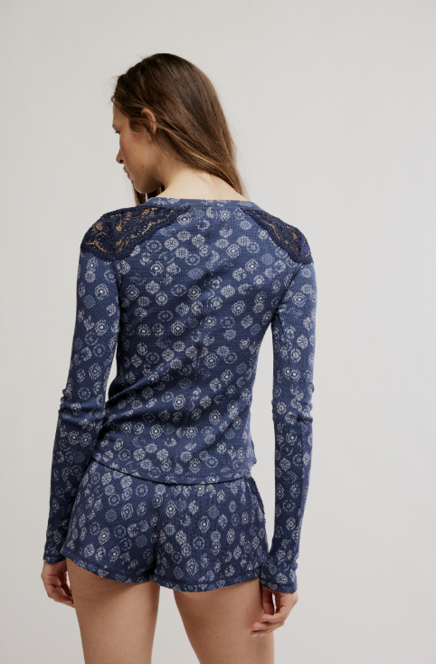 Woman wearing a blue patterned top on white background