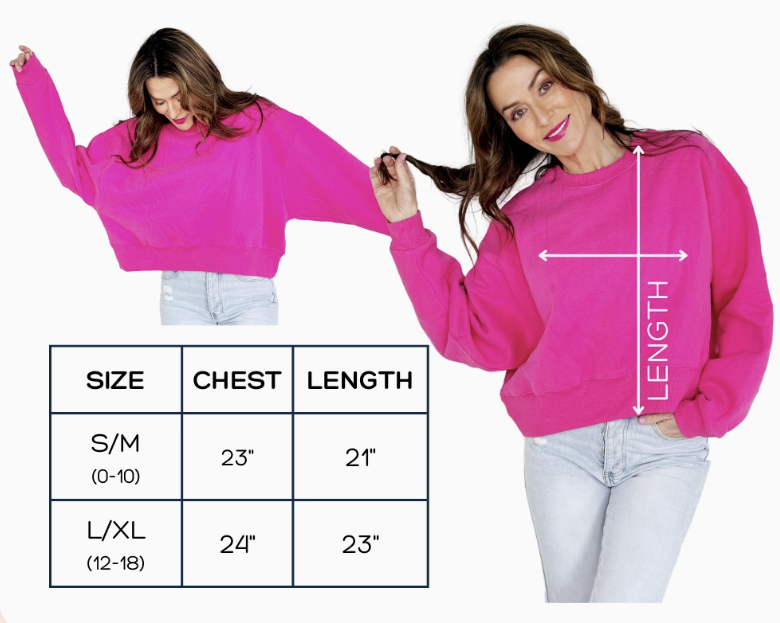 Woman wearing a pink sweatshirt with size chart on a white background