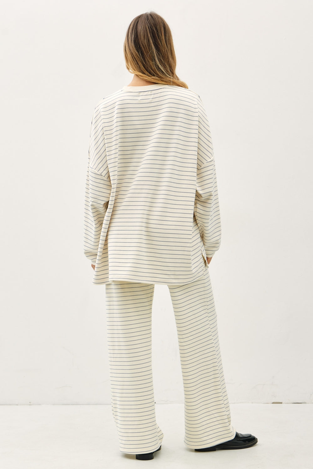 Person wearing a matching striped outfit on a white background