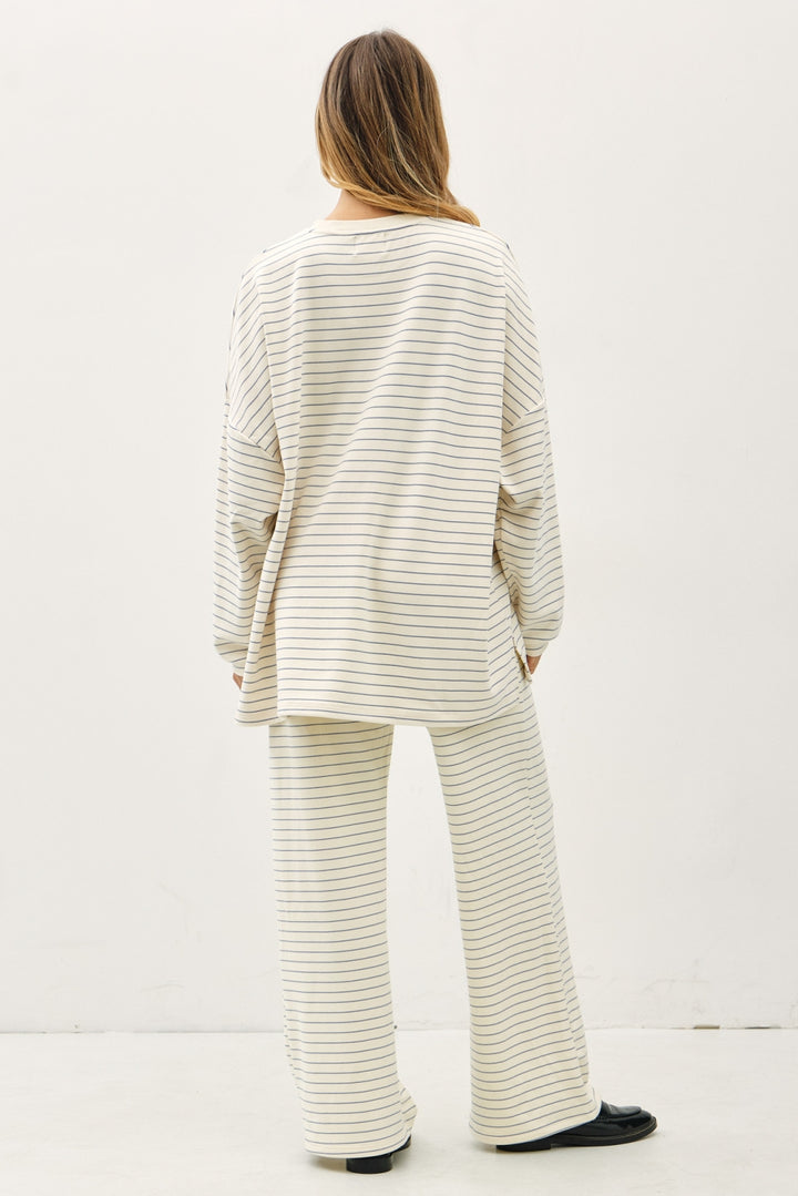 Person wearing a matching striped outfit on a white background