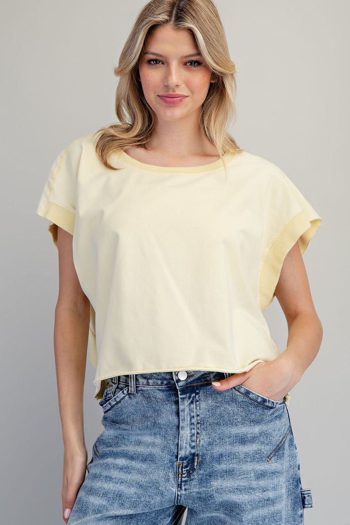 Woman wearing yellow tshirt on plain background