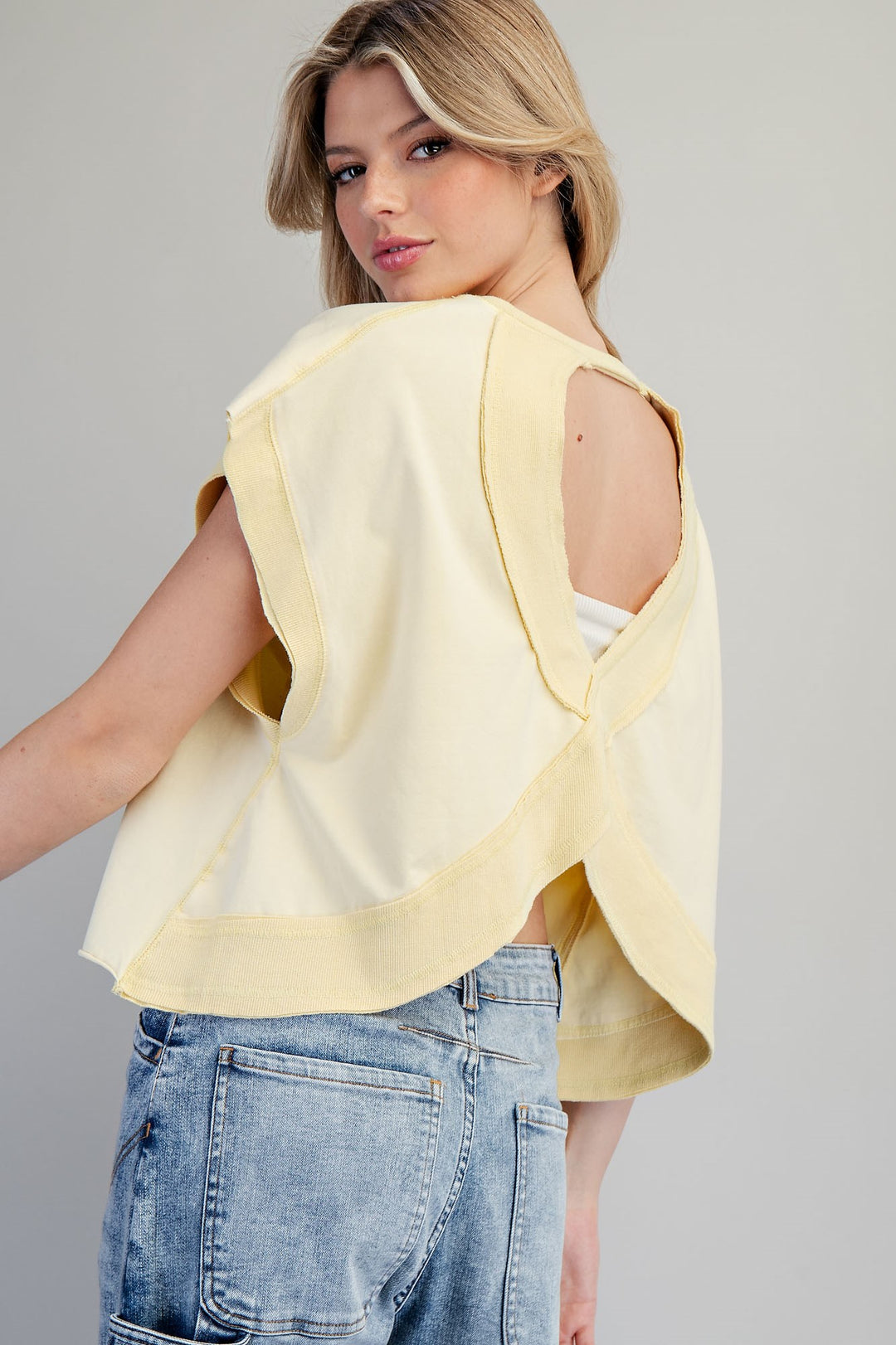 Woman wearing yellow tshirt on plain background