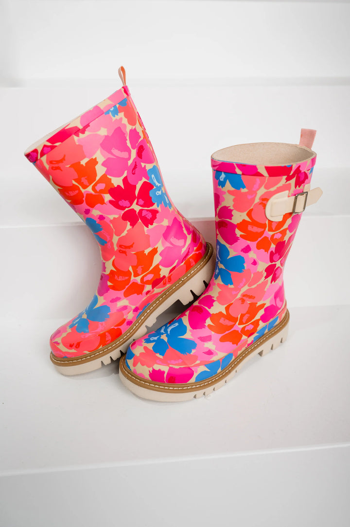 Pair of pink floral-patterned rain boots on a white background