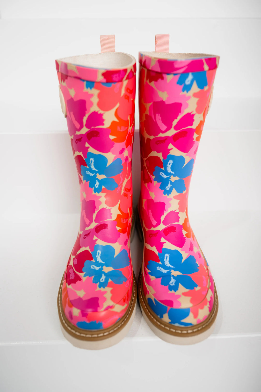 Pair of colorful floral-patterned rain boots on a white background