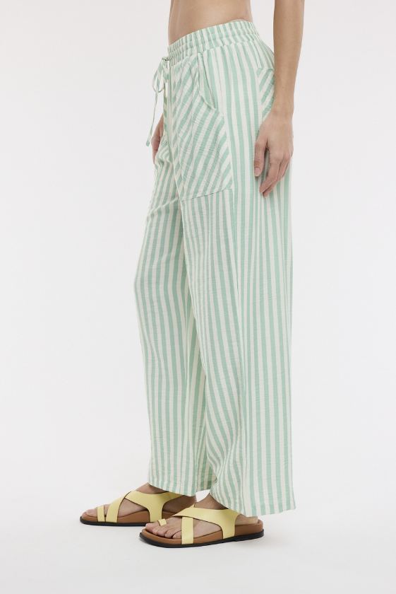 Woman wearing green stripe pants on white background