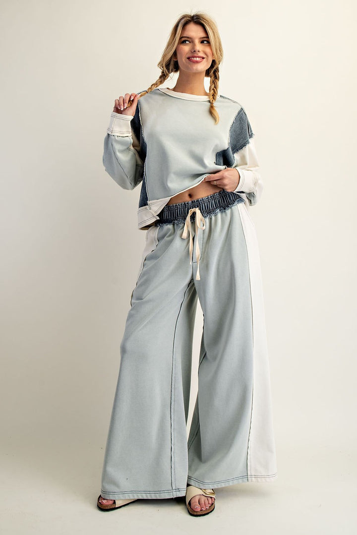 Woman wearing green and denim matching set on plain background
