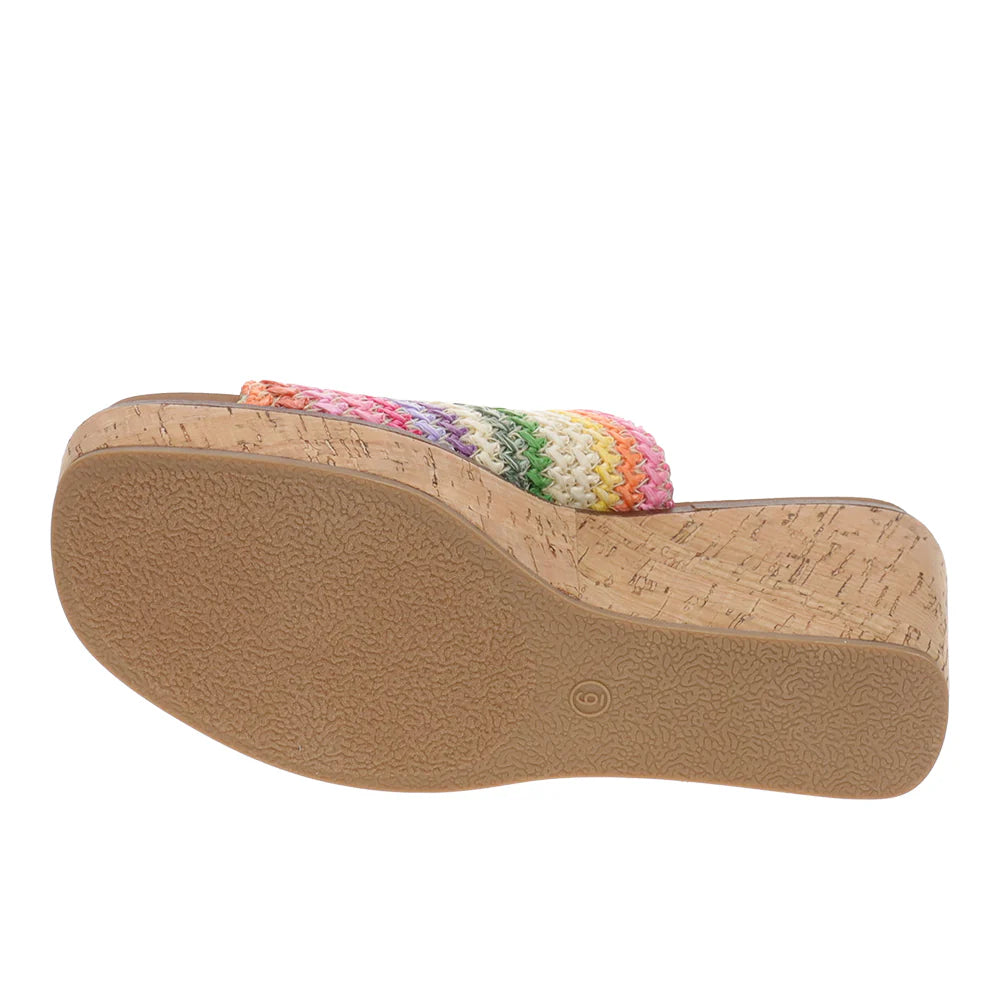 Wedge sandal with cork wedge and colorful woven strap on a white background